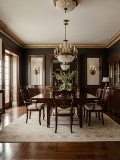 an elegant dining room with chandelier and wooden furniture in the middle of it