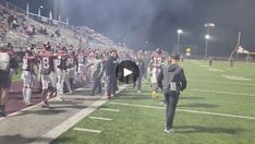 the football team is walking onto the field