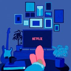 a person's feet resting on a table in front of a television