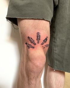 a man's leg with tattoos on it and his legs are covered in black ink