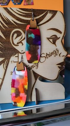 a pair of colorful earrings on display in a store