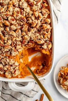 a casserole dish filled with sweet potatoes and pecans