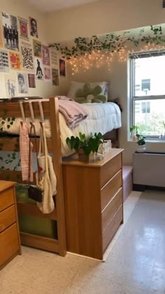 a bedroom with a bed, dresser and hanging planters on the wall next to it