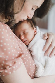 a woman holding a baby in her arms