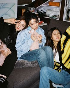 four young women sitting on a couch together