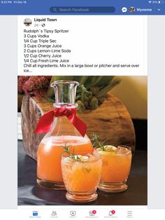 two glasses filled with orange juice and garnished with a red bow on top