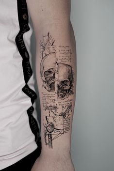 a man with a tattoo on his arm has a skull in the middle of it