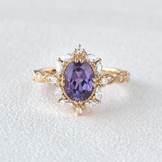 a ring with an amethorate surrounded by diamonds