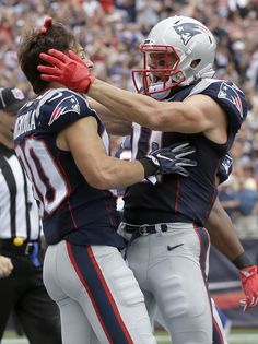 two new england football players are congratulating each other