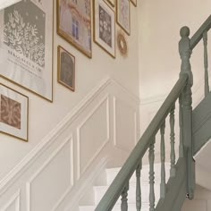 stairs with pictures on the wall above them