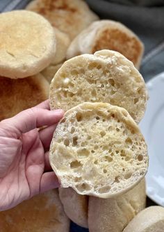 two pieces of bread are being held up by someone's hand in front of them