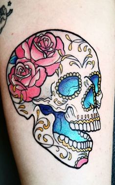 a tattoo with a skull and roses on it