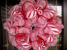 a red and white wreath with candy canes on it