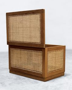 two wicker boxes sitting on top of each other in front of a white background