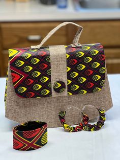 Handbag made with African fabric comes with a pair of earrings and a bracelet. A Perfect gift for mothers day. Beige Fabric Bag As A Gift, Beige Fabric Bag For Gift, Beige Fabric Bag Gift, Rectangular Fabric Shoulder Bag As Gift, Casual Fabric Shoulder Bag As Gift, Red Adjustable Bags For Gifts, Multicolor Bags For Mother's Day Gift, Fabric Tote Shoulder Bag As Gift, Mother's Day Multicolor Bags As Gift