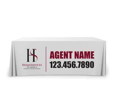 a white table cloth with the name and number on it for an event or business