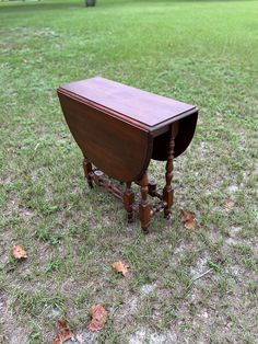 an old wooden table sitting in the middle of a field