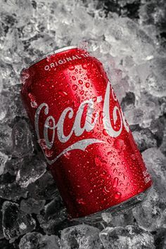 a can of coca cola sitting on top of ice