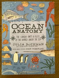 an ocean anatomy book on a wooden table