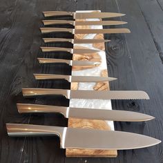 several knives are lined up on a table