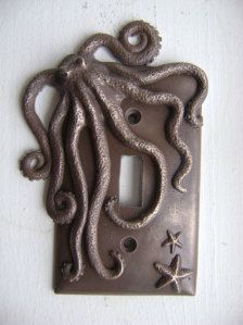 an octopus light switch plate cover on a white wall with starfish and sea stars