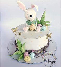 a cake decorated with an easter bunny sitting on top of it