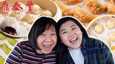 two women are smiling in front of some dumplings and sauces on the table