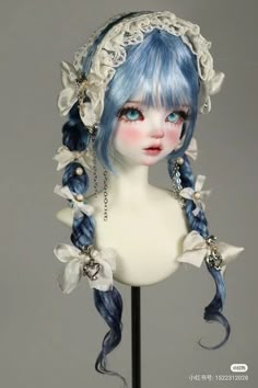 a white mannequin with blue hair and braids on it's head