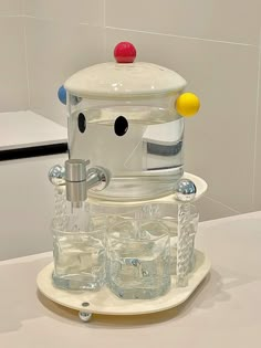 a water dispenser made to look like a face with glasses on it