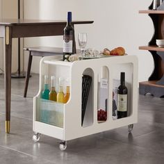 a wine rack with bottles and glasses on it in the middle of a floored room