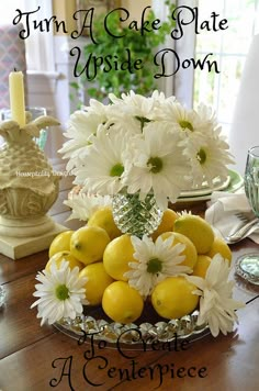 there is a bowl full of lemons and daisies on the dining room table