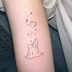 a woman's arm with a small tattoo design on the left side of her arm