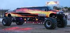 a monster truck with flames painted on it