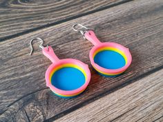 "Show off your pansexual pride and love for puns with these Frying Pan Pride Earrings! 3D printed in 3 colours, these lightweight pan pride earrings are sure to delight! Size: Total Earring Length 2.4\" (60mm). Each Pan is 1.5\"(40mm) tall, 1\" (25mm) wide and .25\"(7mm) thick. Hanging on stainless steel earring hooks. 3D printed from strong, vibrant and waterproof PLA filament." Acexual Earrings, Bigender Earrings, Pride Jewelry Earrings, Gay Dangle Earrings, Omnisexual Earrings, Pan Pride, Pride Earrings, Pride Jewellery, French Wire Earrings