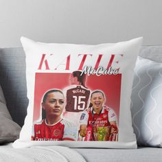 a throw pillow with an image of two women in red and white on the front