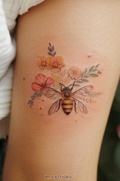 a woman's thigh with flowers and a bee on it