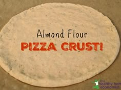 an uncooked pizza crust with the words almond flour written on it in red