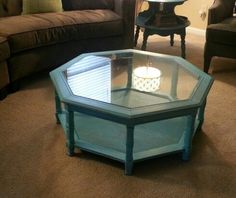 a living room with two couches and a glass top coffee table in the middle