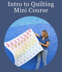 a woman holding up a quilt on top of a blue background with the words, learn to