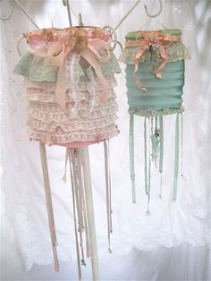 there are two lamps that have ribbons on the top and bottom one is blue, pink, and green