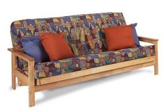 a wooden couch with colorful pillows on it