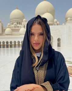 a woman in a black hoodie is holding a ball