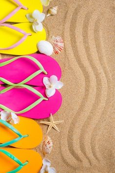 colorful flip flops and starfish on the beach