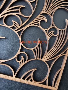 an intricate wood carving pattern on a black surface