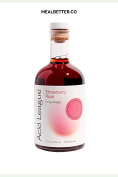 a bottle of strawberry rose syrup on a white background with the label above it that says,