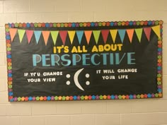 a bulletin board hanging on the wall in a school hallway that says it's all about perspective