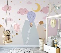 a child's bedroom decorated in pink, blue and white with hot air balloons