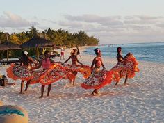 some people are dancing on the beach