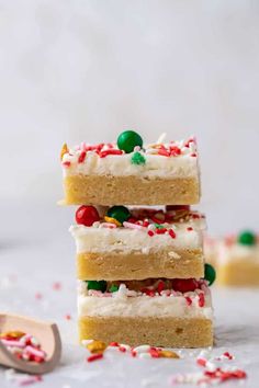 three pieces of cake stacked on top of each other with candy and sprinkles