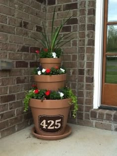 three tiered planter with flowers on the front porch